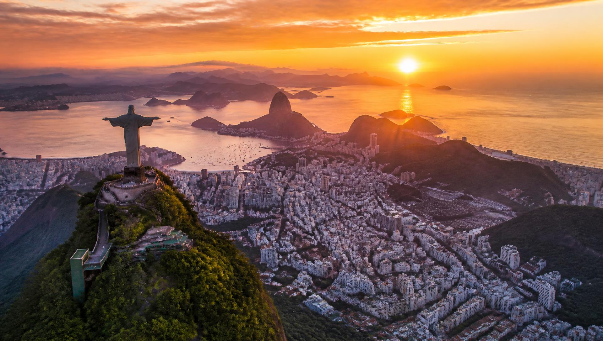 Aerial view of Rio de Janeiro at sunset with Christ the Redeemer and Sugarloaf